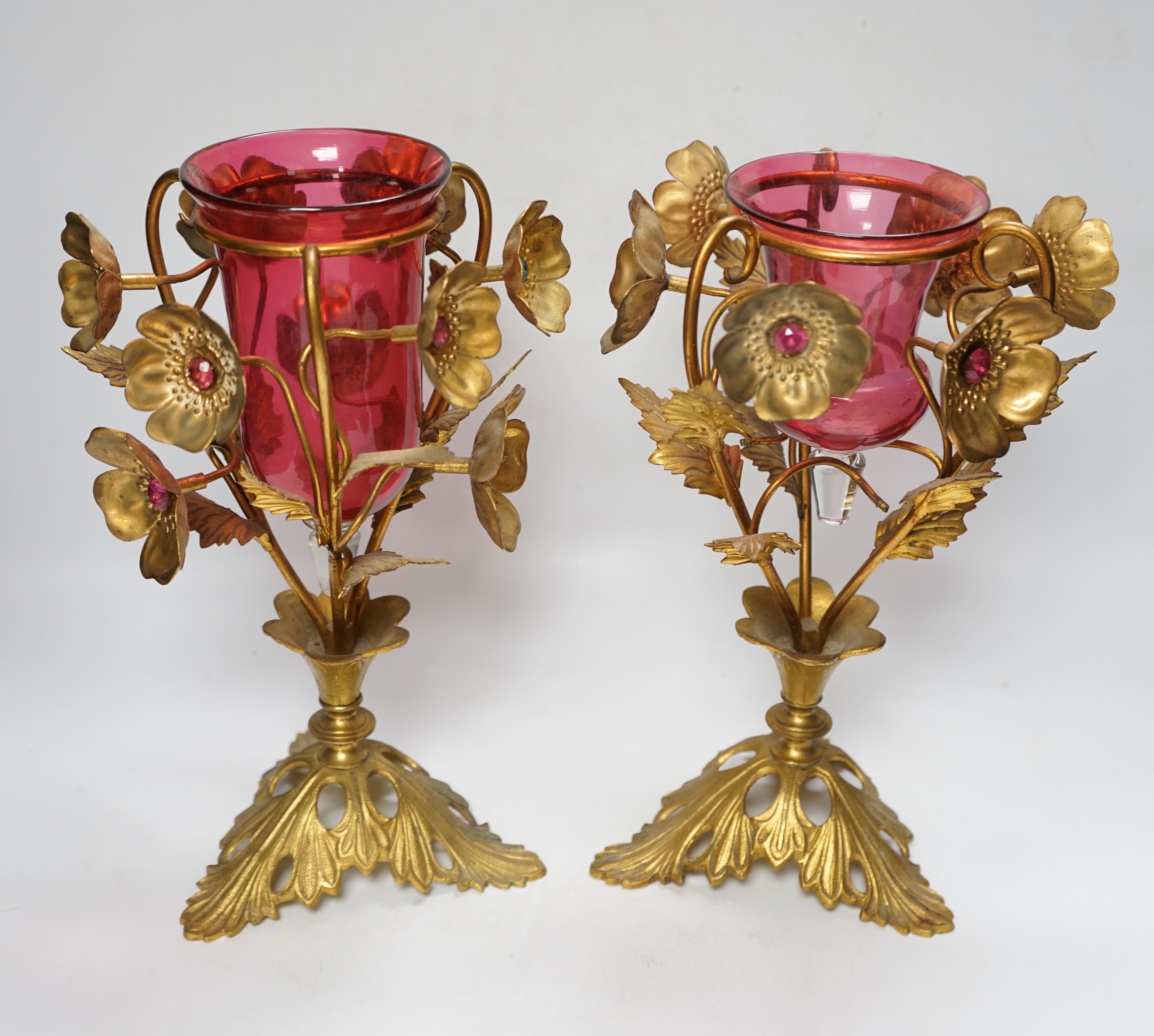A near pair of early 20th century cranberry glass and gilt metal ornate vases, 31cm
